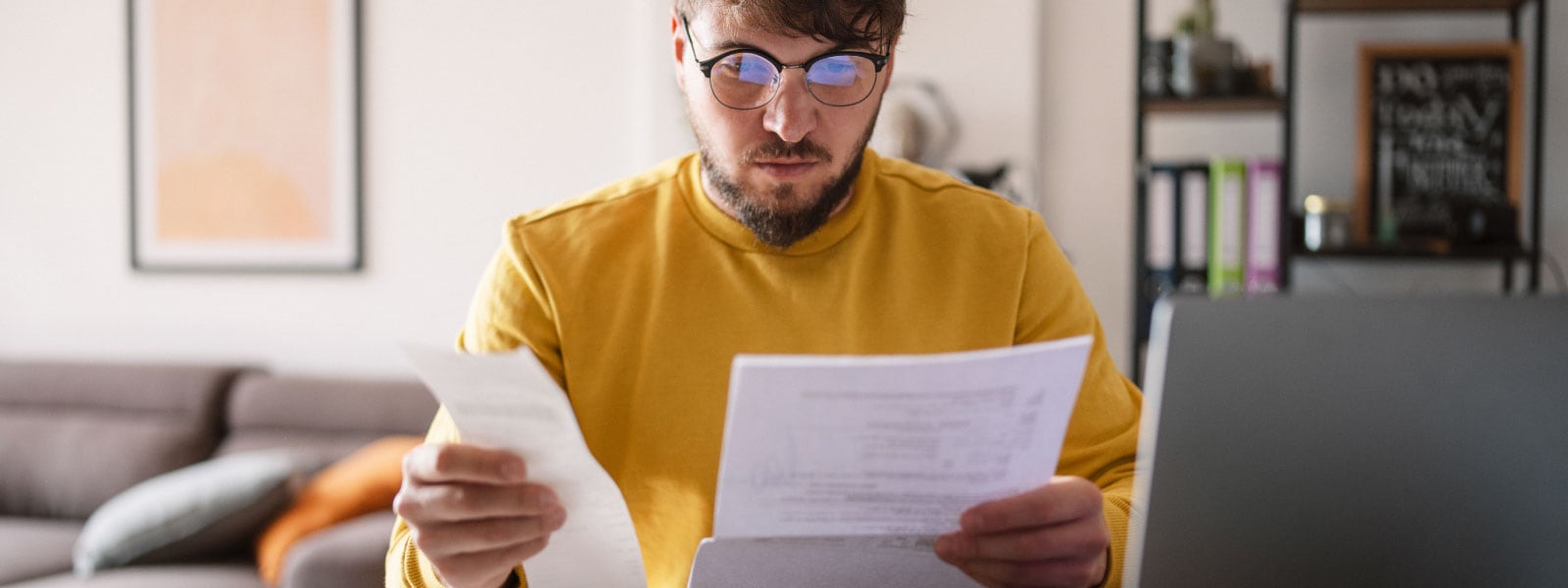A person reviews their finances to avoid falling prey to tax scams.