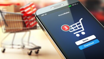 Screen of smart phone with online checkout shopping cart icon
